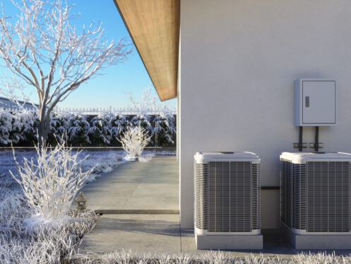 Heat pump in a snowy backyard